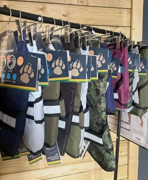 A rail of Danish Design 3-in-1 dog coats in navy, olive, camouflage and plum