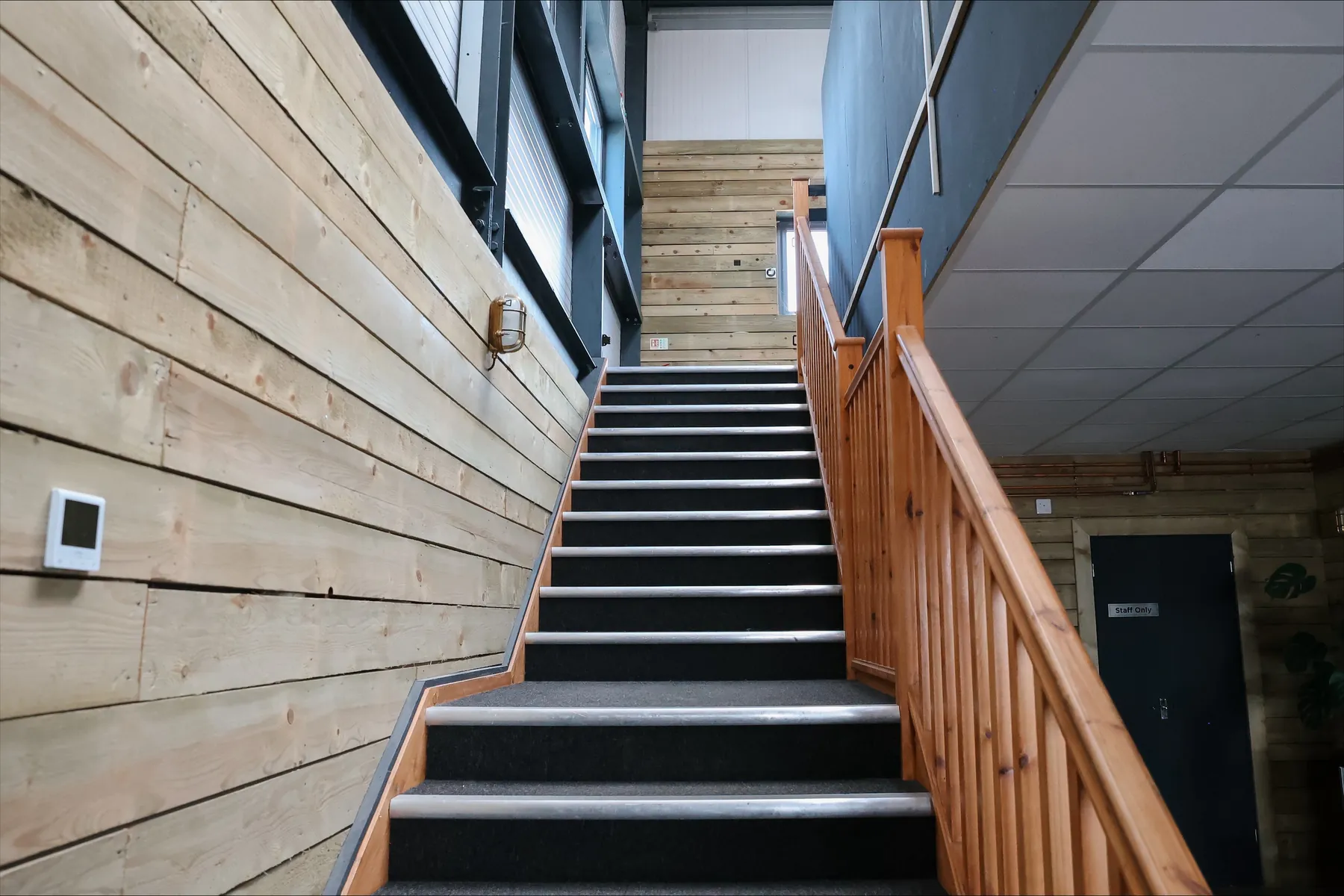 The timber-clad staircase from the shop up to the event space